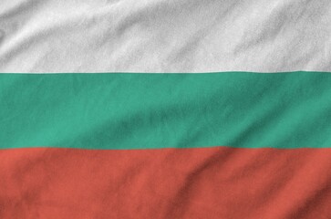 Bulgaria flag depicted on folded wavy fabric of old cloth close up