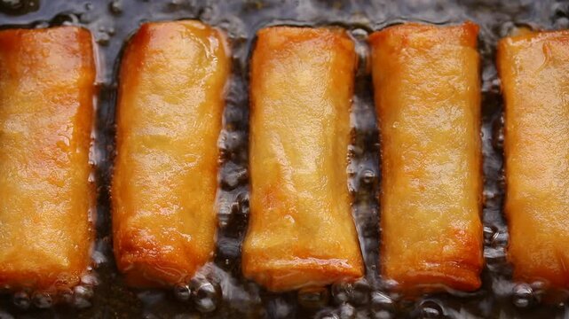 Top view of deep frying spring roll in boiling oil, Chinese food	