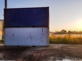 Obraz premium Containers with Sunrise and Fog in the Background