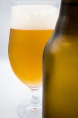 A bottle, a mug with light beer.
