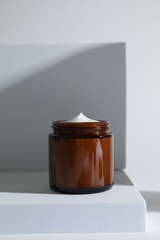 Stylish presentation of facial cream on white background