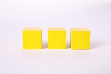 Many yellow wooden cubes isolated on white