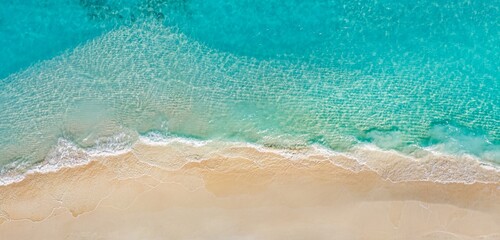 Sunny gold sandy beach, panorama. Panoramic view tranquil sandy beach. Peaceful sea waves shore. Ocean coast view. Aerial photography beachfront. Seaside exotic tropical Mediterranean nature landscape