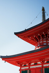 Elements of the red roof of a Japanese temple are red against