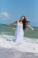 Fototapeta premium Mature woman finds peace and relaxation by the ocean, her carefree demeanor and windblown hair reflecting the bliss of seaside living.