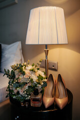 Bride's bouquet, her perfume and her shoes.