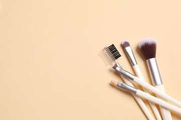 Cosmetic brushes on colored background. Set of makeup brushes