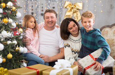 Portrait of family who is satisfied of gifts in time celebration New Year at home