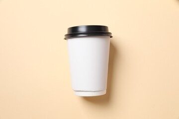 Paper cup of coffee on color background 