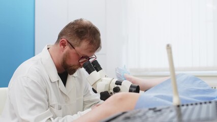 A woman lies on a gynecological chair during a colposcopy procedure. Gynecological office in a modern hospital. The gynecologist uses a colposcope and takes tests from the patient.