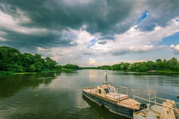 A boat is sitting in the water next to a forest