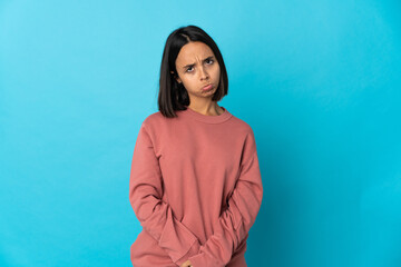 Fototapeta premium Young latin woman isolated on blue background with sad expression