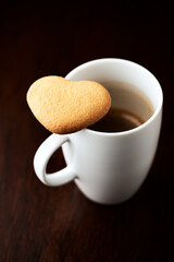 Chocolate cookie and Coffee in glass cup on rustic wooden background. Close up.