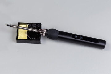 Electric smart temperature controlled soldering iron on the stand