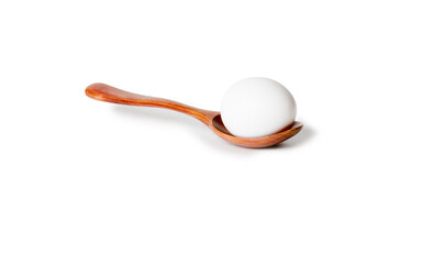 Wooden spoon with chicken egg.