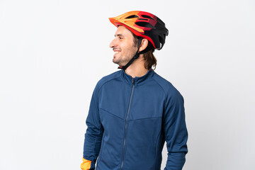 Young cyclist man isolated on white background looking side