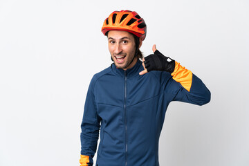 Young cyclist man isolated on white background making phone gesture. Call me back sign