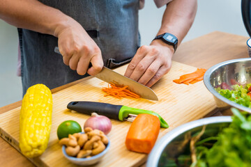 Chef at the kitchen preparing spicy glass noodle salad