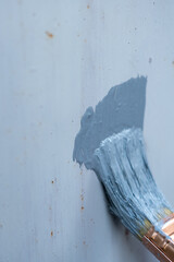 Anti-rust primer brush, on the rusty metal panel
