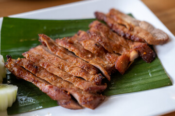 Grilled Pork Neck served on wooden plate