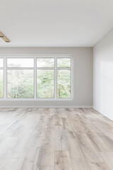 Fototapeta premium Elegant empty room interiors with a large window, neutral colors, natural lighting and copyspace. Empty property interiors.