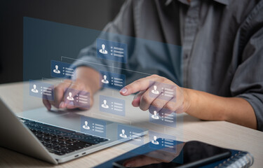 Person managing digital organizational chart on a laptop, indicating structured business management and HR processes. Suitable for corporate, HR, and management content.