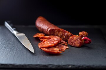 Close-Up 4K image of Slicing Very Thin Salami Sausage for Charcuterie
