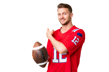 Young caucasian man playing rugby over isolated chroma key background pointing back