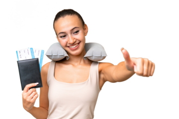 Young Arab woman with Inflatable Travel Pillow over isolated background giving a thumbs up gesture