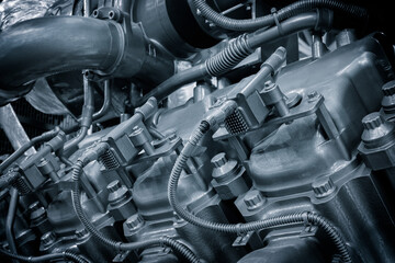 Large industrial diesel engine or diesel generator close-up with many pipes and other parts. Industrial concept background