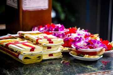  stacks of golden Joss papers arranged neatly on a table for religious ceremonies and offerings