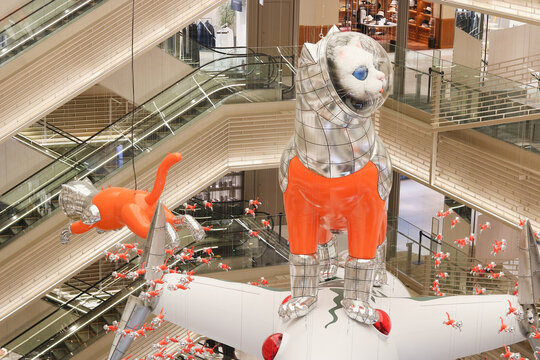 TOKYO, JAPAN - July 25, 2024: Ginza Six shopping mall atrium with the installation 'Big Cat Bang' by Kenji Yanobe. 