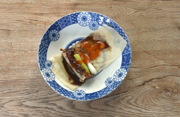 Peking roasted duck with slice cucumber and spring onion spring roll dreessing black sweet soy and chili sauce on plate