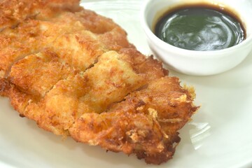 Tonkatsu crispy fried pork with flour dipping swwt soy sauce on plate