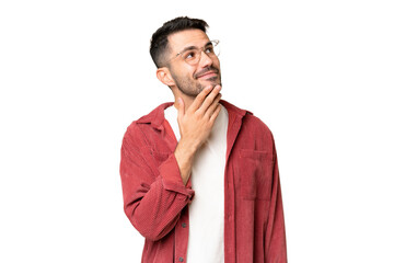 Young handsome caucasian man over isolated chroma key background looking up while smiling