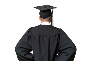 Young university graduate man over isolated chroma key background in back position