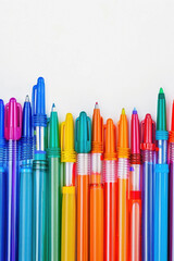 Colorful border composed of an assortment of felt-tipped pens or markers