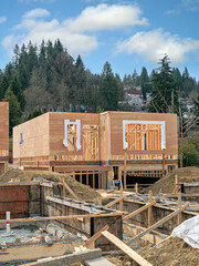 Wooden frame of new house with concrete filled fundation in front