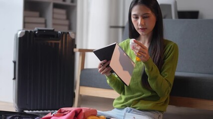 Woman packing for a trip and organizing travel essentials