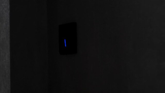 child's hand turns off the light in the room by pressing the touch switch button close-up, child turns off the light before going to bed
