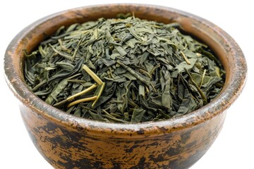 A brown bowl filled with green leaves on a white surface