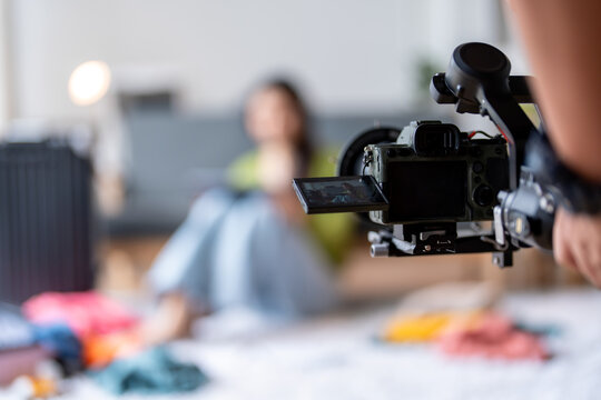 Videographer is recording a video blogger preparing her next travel blog post