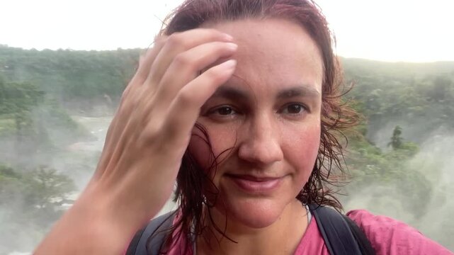 woman wet hair from water portrait making selfie in front of iguasu falls travel tourism places concept