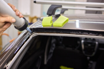 Use professional adhesive when repairing windshield glass for autos to ensure a secure installation