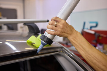 Use professional adhesive when repairing windshield glass for autos to ensure a secure installation