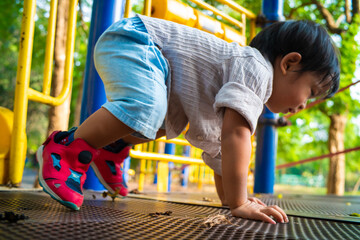 Toddler preschool boy playing slider outdoor park