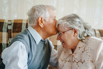 Elderly senior romantic love couple. Old retired man woman together. Aged husband wife in cozy home...