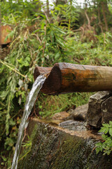 water flowing from a wood pipe