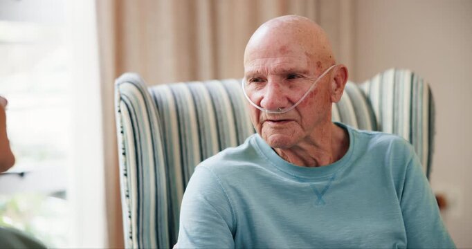 Conversation, oxygen and retirement with old couple in living room of home for recovery or rehabilitation. Breathing, comfort or medical with senior man and woman talking in apartment for healthcare
