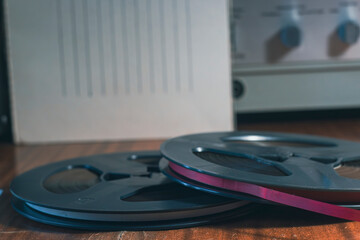 Vintage reel-to-reel tape recorder on wooden table